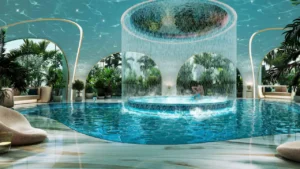 Luxury indoor spa pool at DAMAC Casa featuring a circular cascading waterfall pavilion, tranquil water lounge seating, and tropical-inspired interiors designed for resort-style wellness living. Presented by Tohid Fetrat.