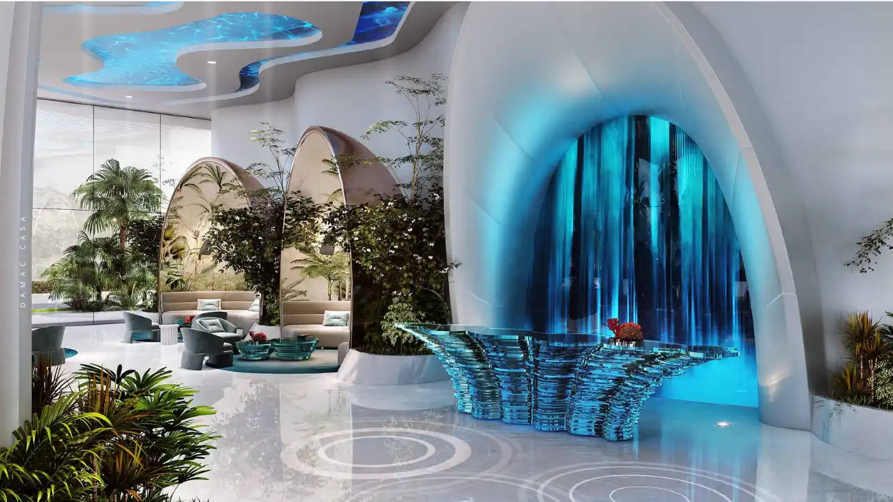 DAMAC Casa luxury lobby interior showcasing organic architectural forms, cascading water feature, aquatic-inspired ceiling lighting, and lush indoor greenery, creating a resort-style arrival experience in Dubai. Presented by Tohid Fetrat.