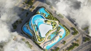Aerial view of the podium amenities at DAMAC Casa, featuring landscaped decks, interconnected infinity pools, leisure zones, and resort-style water features within a luxury residential development in Dubai. Presented by Tohid Fetrat.