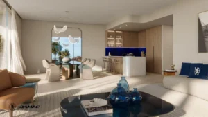 Interior view of the dining and kitchen area at DAMAC Chelsea Residences featuring a modern dining table, sculptural lighting, open kitchen with island seating, and refined contemporary finishes in Dubai, Presented by Tohid Fetrat