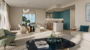 Open plan dining and kitchen interior at DAMAC Chelsea Residences featuring a sculptural dining table, soft contemporary seating, an island kitchen with bar stools, and calm natural tones in Dubai, Presented by Tohid Fetrat