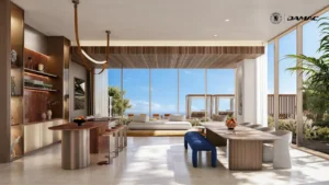 Interior view of the healthy fine dining restaurant at DAMAC Chelsea Residences featuring elegant dining tables, a refined bar area, natural materials, and floor to ceiling windows opening to landscaped outdoor seating in Dubai, Presented by Tohid Fetrat