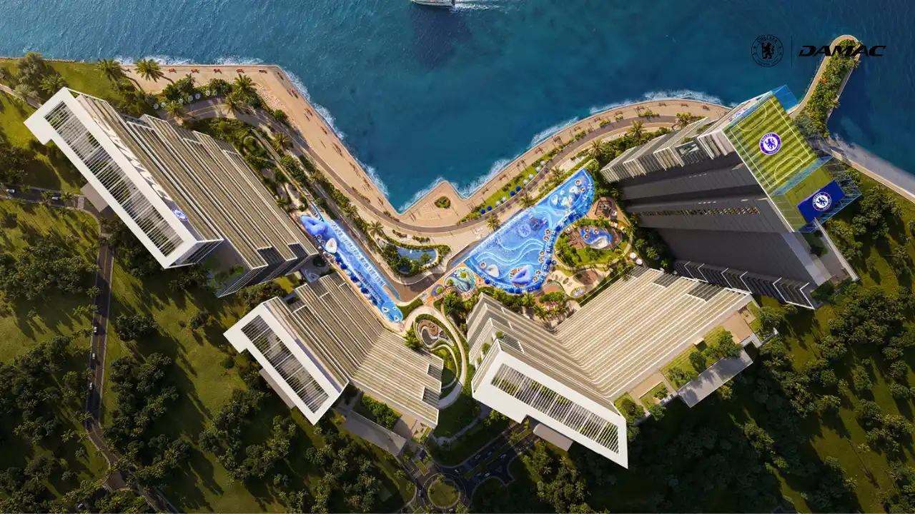 Aerial view of the jogging track at DAMAC Chelsea Residences winding through landscaped grounds alongside waterfront leisure areas and blue pool features in Dubai, Presented by Tohid Fetrat