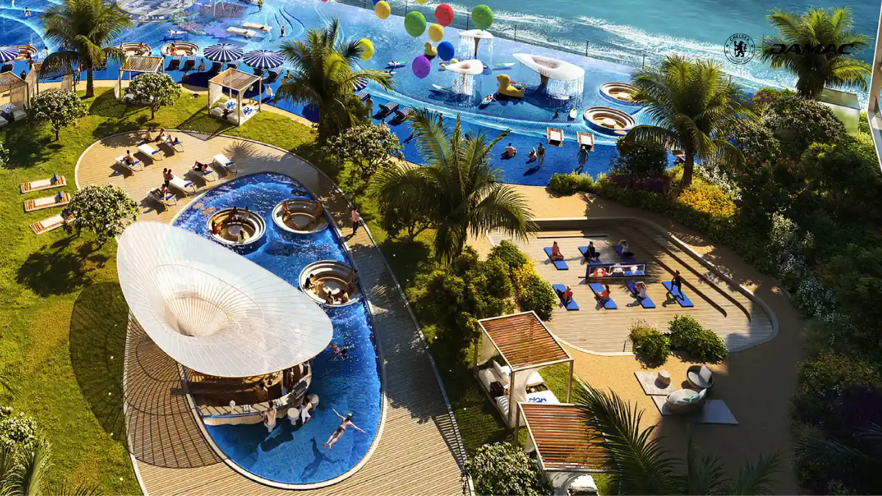 Outdoor yoga area at DAMAC Chelsea Residences featuring a dedicated wellness deck, blue pool surroundings, lush landscaping, and a calm waterfront setting in Dubai, Presented by Tohid Fetrat