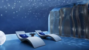 Interior view of the Starlit Wellness Centre at DAMAC Chelsea Residences featuring sculpted relaxation loungers, star like ceiling lighting, flowing architectural screens, and a tranquil blue toned recovery environment in Dubai, Presented by Tohid Fetrat