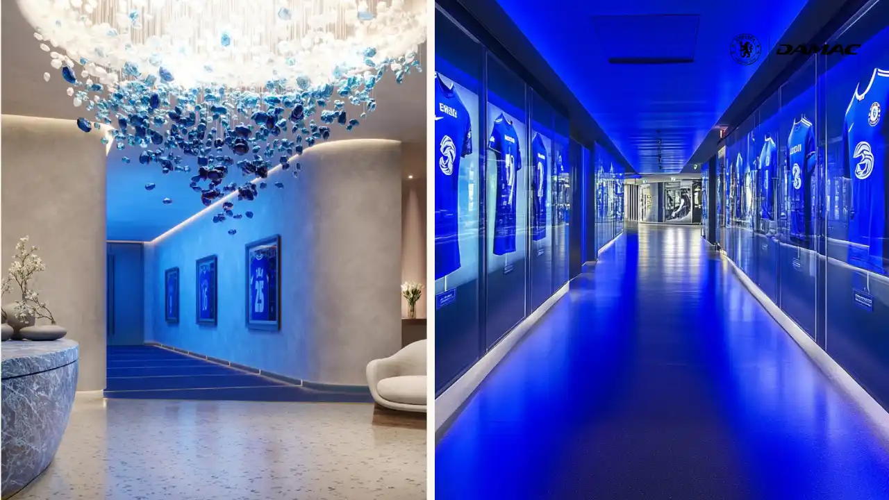 Interior view of The Legends’ Walkway at DAMAC Chelsea Residences featuring a dramatic blue illuminated corridor, framed Chelsea memorabilia displays, sculptural lighting, and a refined immersive passage in Dubai, Presented by Tohid Fetrat
