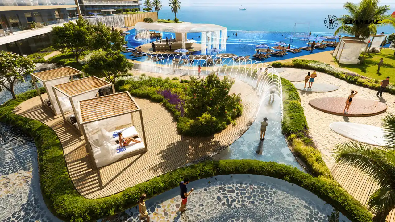 Poolside view of the water treatment tunnel at DAMAC Chelsea Residences featuring arched water jets, landscaped pathways, private cabanas, and a resort style leisure environment by the waterfront in Dubai, Presented by Tohid Fetrat