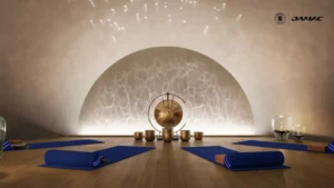Interior view of the waterfall sound therapy room at DAMAC Chelsea Residences featuring a serene arched backdrop, ambient star like ceiling lighting, yoga mats, and a tranquil wellness setting in Dubai, Presented by Tohid Fetrat