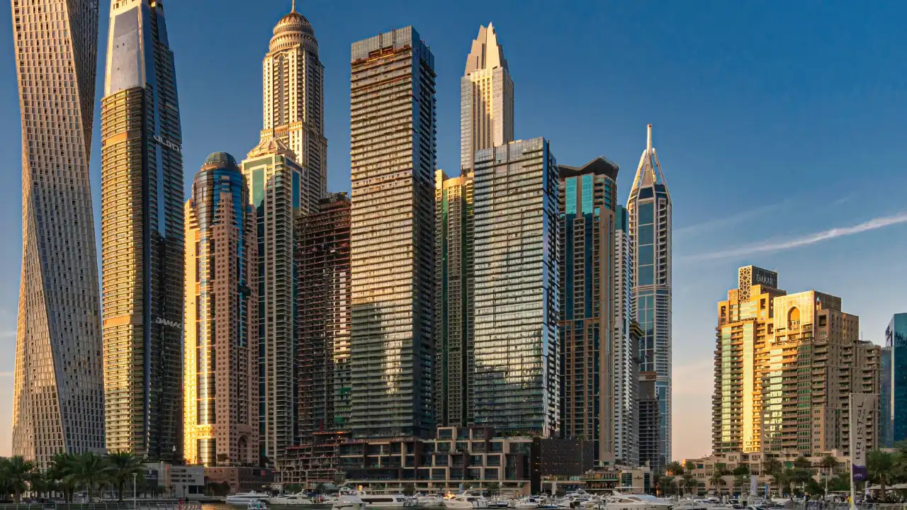 Dubai skyline overlooking the Marina with high rise residential towers, waterfront promenades, and moored yachts, symbolizing the importance of the Sales and Purchase Agreement SPA contract in regulated Dubai real estate transactions. Presented by Tohid Fetrat.