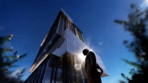 Close-up facade view of Haus of Tenet by IRTH in Business Bay, Dubai, showcasing sharp contemporary architecture, reflective glass surfaces, and a dramatic upward perspective, presented by Tohid Fetrat