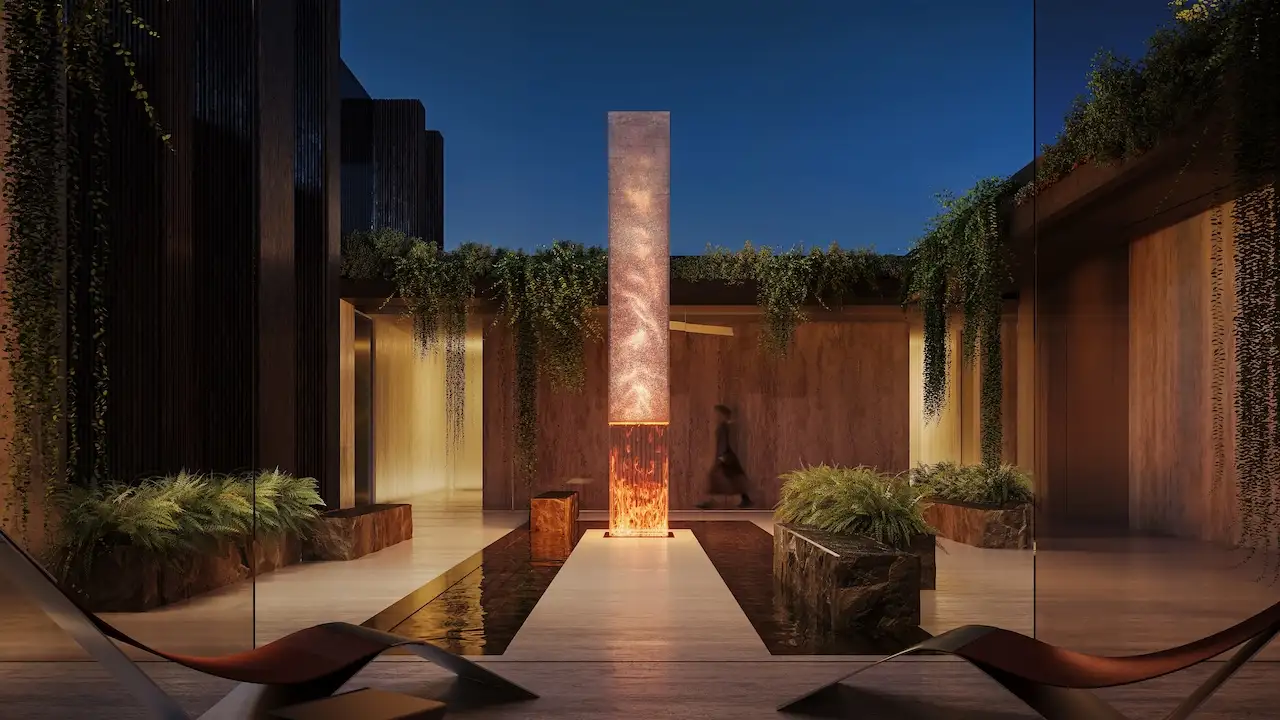 Central courtyard at Haus of Tenet by IRTH in Business Bay, Dubai, featuring a sculptural illuminated water feature, tranquil reflecting pool, lush greenery, and refined contemporary architecture, presented by Tohid Fetrat