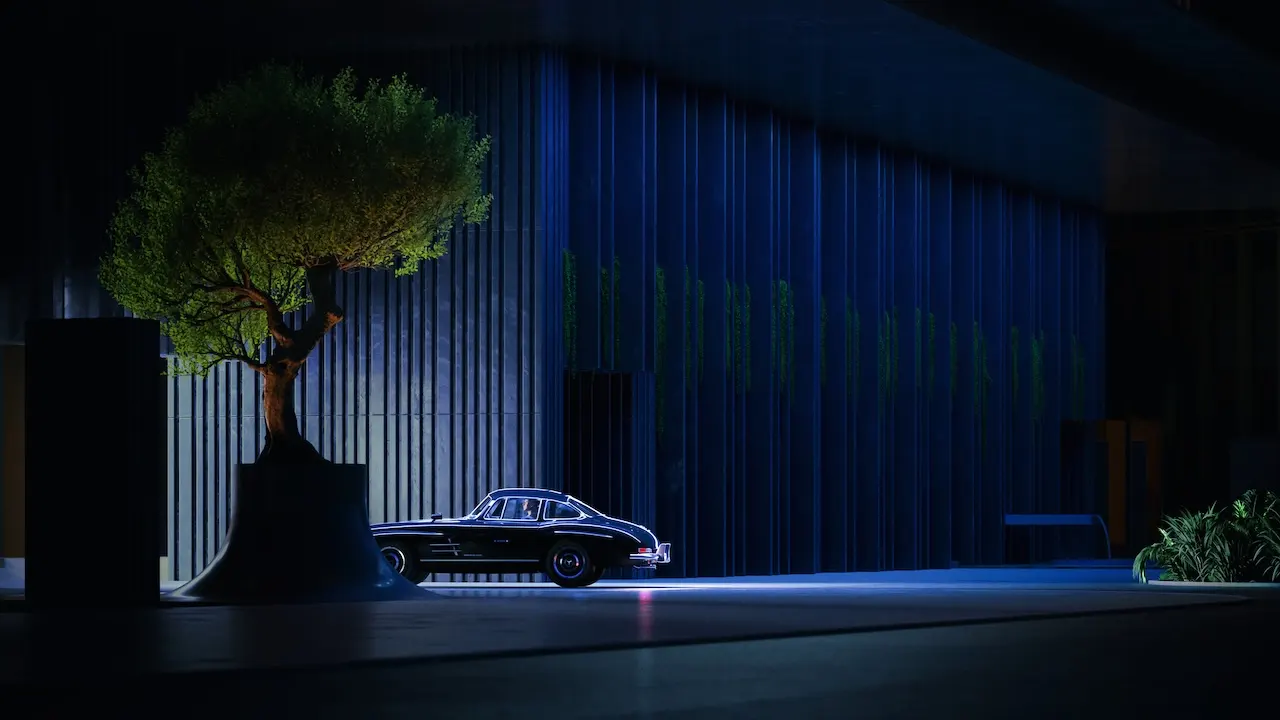 Luxury drop-off entrance at Haus of Tenet in Dubai featuring a classic car, sculptural tree, and dramatic architectural lighting at night, presented by Tohid Fetrat
