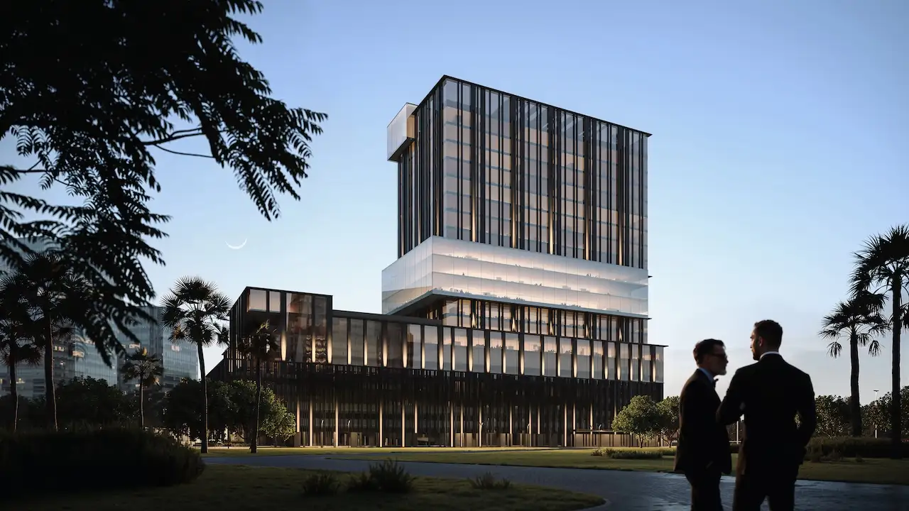Daytime park view of Haus of Tenet by IRTH in Business Bay, Dubai, featuring a contemporary glass-and-metal architectural composition set within landscaped green areas and palm-lined surroundings, presented by Tohid Fetrat
