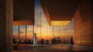 Sunset view of the vitality pool at Haus of Tenet by IRTH in Business Bay, Dubai, featuring a dramatic architectural water feature, reflective pool surfaces, and panoramic city skyline views, presented by Tohid Fetrat
