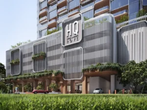 Arrival exterior of HQ by Rove showcasing contemporary architecture with branded facade signage, landscaped balconies, and shaded drop off area in Dubai, Presented by Tohid Fetrat