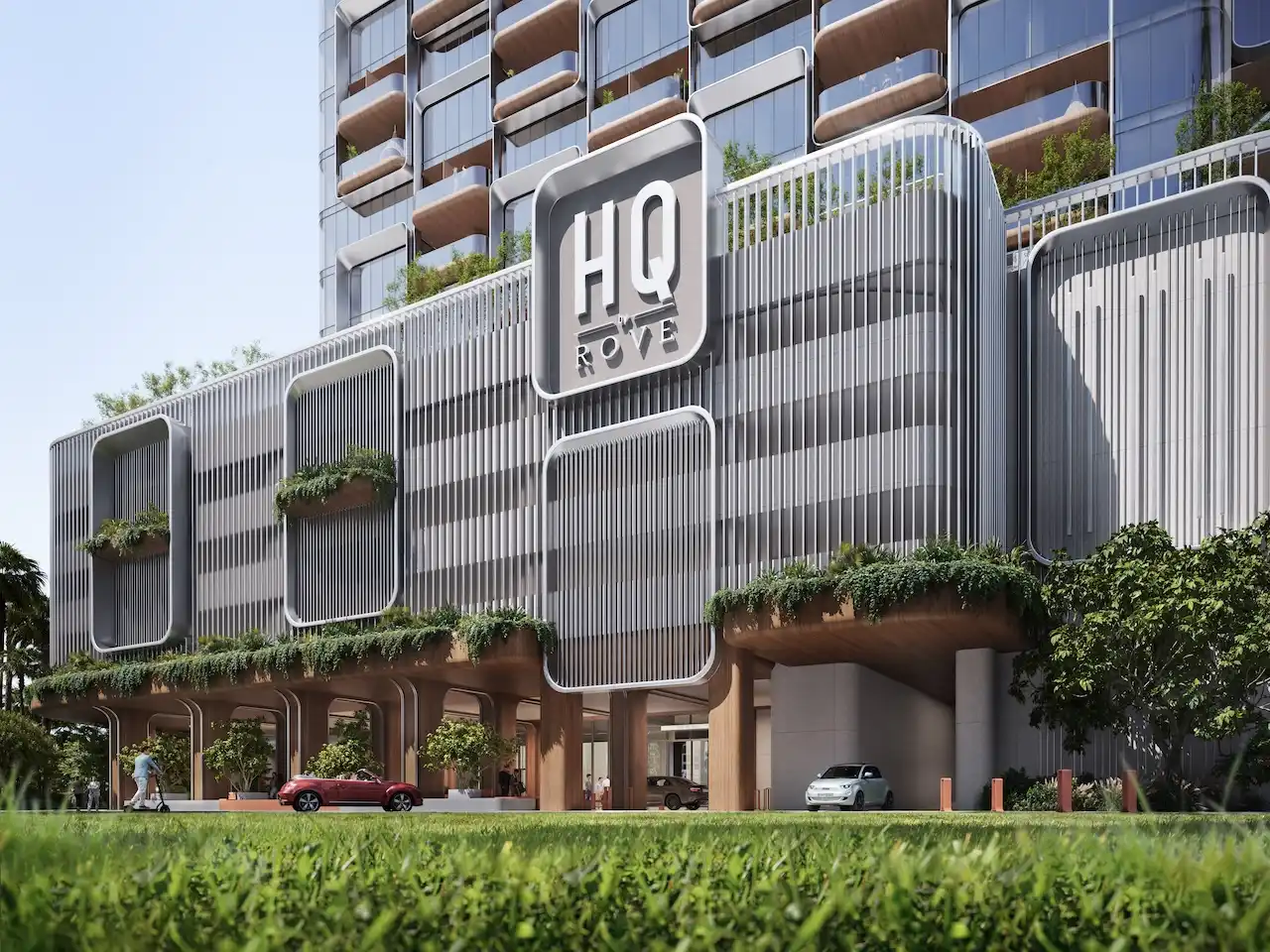 Arrival exterior of HQ by Rove showcasing contemporary architecture with branded facade signage, landscaped balconies, and shaded drop off area in Dubai, Presented by Tohid Fetrat