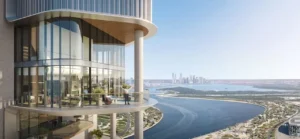 Balcony view at HQ by Rove featuring a curved glass facade, elevated outdoor terrace, and panoramic canal and city skyline views in Dubai, Presented by Tohid Fetrat