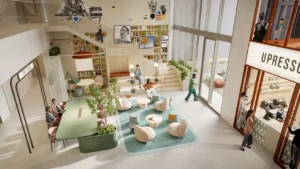 Communal lounge hub at HQ by Rove featuring a double height interior with shared seating, reading steps, indoor greenery, and natural daylight in Dubai, Presented by Tohid Fetrat