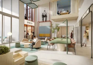 Multi level communal hub at HQ by Rove featuring lounge seating, shared tables, double height space, and integrated greenery with café frontage in Dubai, Presented by Tohid Fetrat