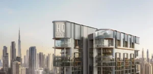 Crown exterior view of HQ by Rove highlighting the upper levels with curved glass balconies, refined facade detailing, and the Dubai skyline in the background, Presented by Tohid Fetrat