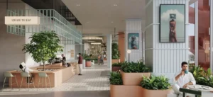 Food hall café interior at HQ by Rove featuring a contemporary counter, indoor greenery, curated artwork, and a relaxed social atmosphere in Dubai, Presented by Tohid Fetrat