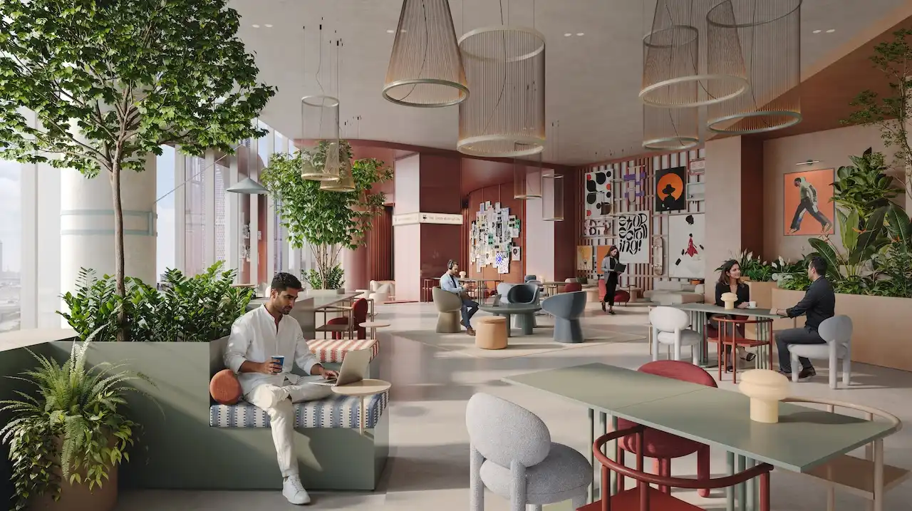 Food hall lounge interior at HQ by Rove featuring relaxed seating, indoor trees, artistic walls, and a vibrant social workspace atmosphere in Dubai, Presented by Tohid Fetrat