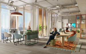 Open workspace interior at HQ by Rove featuring shared desks, lounge seating, indoor greenery, and large windows with Dubai skyline views, Presented by Tohid Fetrat
