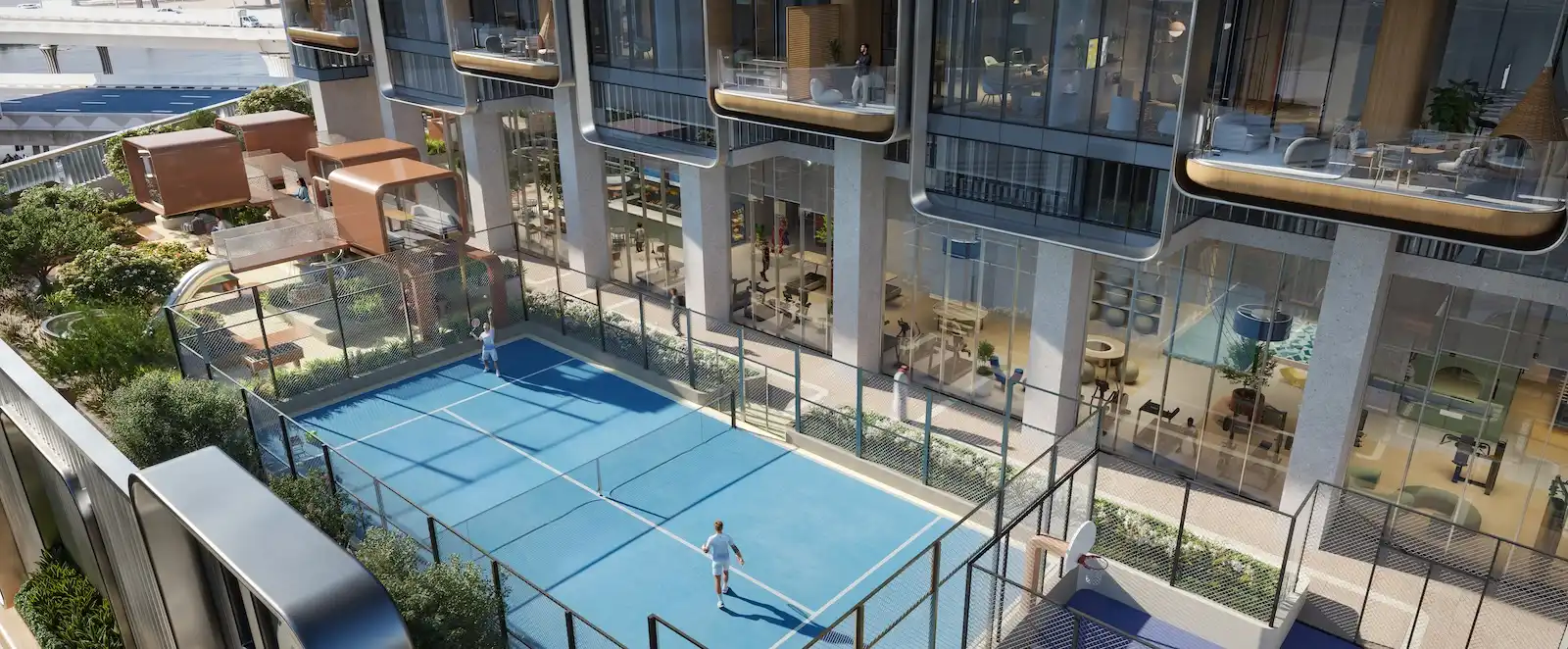 Outdoor sports court at HQ by Rove featuring an elevated multi-purpose court surrounded by landscaped terraces and glass-fronted workspaces in Dubai, Presented by Tohid Fetrat