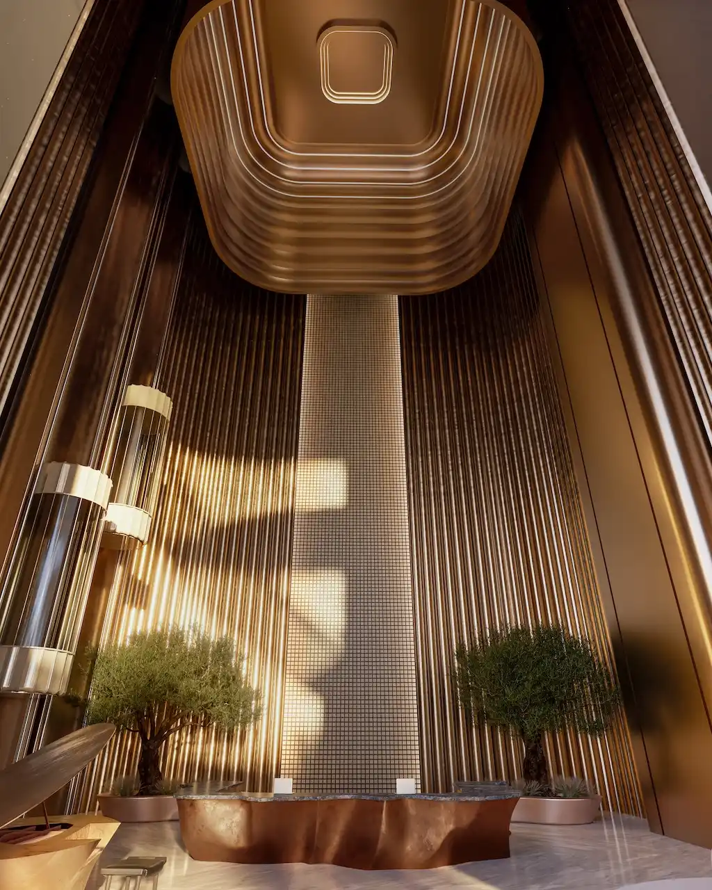 Grand double-height lobby interior at Lumena Alta featuring sculptural architectural design, warm metallic finishes, vertical lighting elements, and refined luxury details. Presented by Tohid Fetrat.
