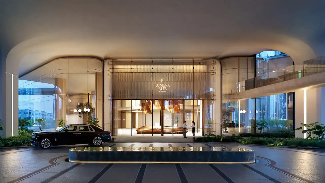 Luxury residential entrance at Lumena Alta featuring a grand architectural canopy floor-to-ceiling glass lobby refined lighting design and premium drop-off area in Dubai. Presented by Tohid Fetrat.