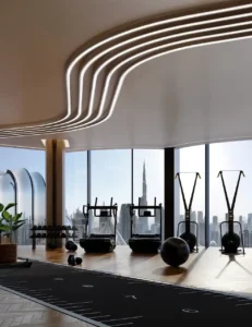 Sky gym at Lumena Alta featuring premium fitness equipment, sculpted ceiling design, floor-to-ceiling windows, and panoramic Burj Khalifa views in Dubai. Presented by Tohid Fetrat.