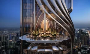 Sky lounge terrace of Lumena Alta integrated into a sculptural glass façade, featuring an elevated social deck with panoramic night views over Dubai’s illuminated skyline. Presented by Tohid Fetrat.