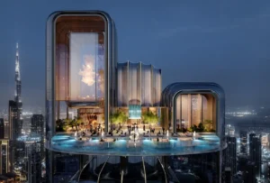 Elevated sky terrace of Lumena Alta with sculptural glass architecture, illuminated infinity pool, and panoramic night views of Dubai skyline with Burj Khalifa in the background. Presented by Tohid Fetrat.