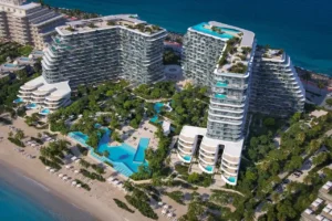 Aerial hero view of Passo by Beyond on Palm Jumeirah, showcasing luxury beachfront residential buildings, landscaped central park, resort-style swimming pools, and direct access to the Gulf coastline in Dubai. Presented by Tohid Fetrat.