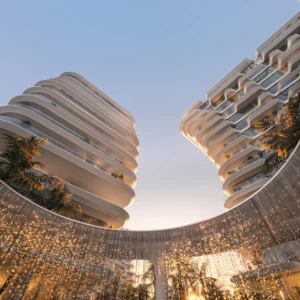 Arrival water feature at Passo by Beyond on Palm Jumeirah, featuring cascading illuminated water curtains framed by sculpted curved towers and contemporary luxury architecture. Presented by Tohid Fetrat.