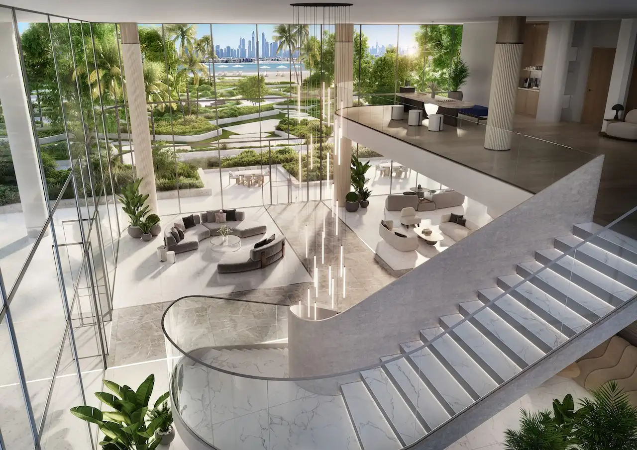 Double height glass box living area at Passo by Beyond Palm Jumeirah featuring floor to ceiling glazing landscaped gardens panoramic Gulf and Dubai skyline views and refined contemporary architecture. Presented by Tohid Fetrat.