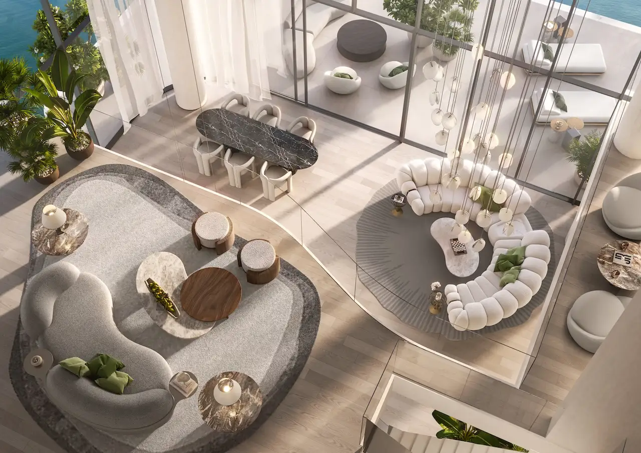Double height penthouse living room at Passo by Beyond Palm Jumeirah featuring sculptural seating elegant dining area floor to ceiling glass and seamless indoor outdoor luxury design. Presented by Tohid Fetrat.