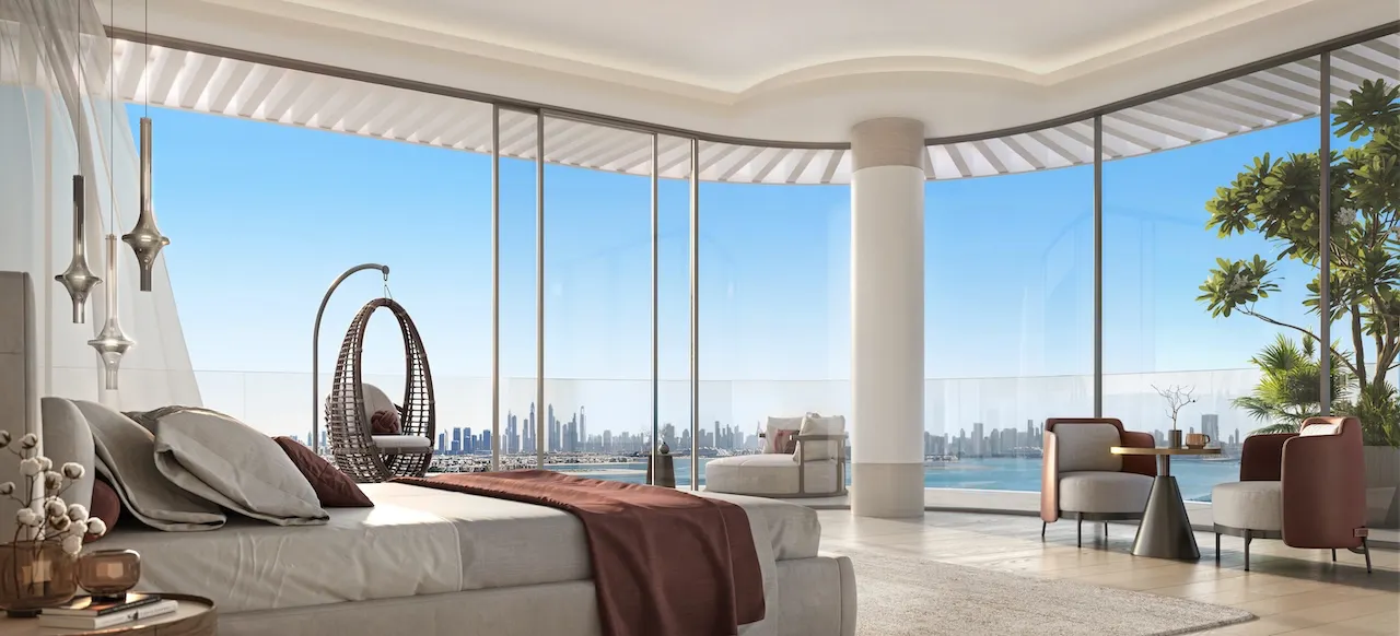 Penthouse master bedroom at Passo by Beyond Palm Jumeirah featuring floor to ceiling glass panoramic sea views elegant seating area and refined luxury interior design. Presented by Tohid Fetrat.