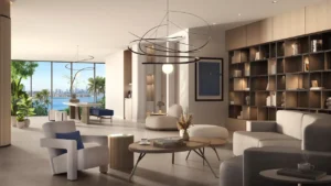 Residents library and lounge at Passo by Beyond Palm Jumeirah featuring a refined reading space with custom bookshelves modern seating sculptural lighting floor to ceiling windows and serene waterfront views designed for quiet relaxation and work. Presented by Tohid Fetrat.