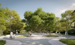 Amazon Park entrance at Sobha Elwood featuring a central heritage tree, landscaped walking paths, shaded green areas, and family-friendly open spaces within a master-planned residential community in Dubai, Presented by Tohid Fetrat
