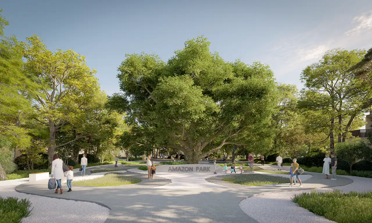 Amazon Park entrance at Sobha Elwood featuring a central heritage tree, landscaped walking paths, shaded green areas, and family-friendly open spaces within a master-planned residential community in Dubai, Presented by Tohid Fetrat