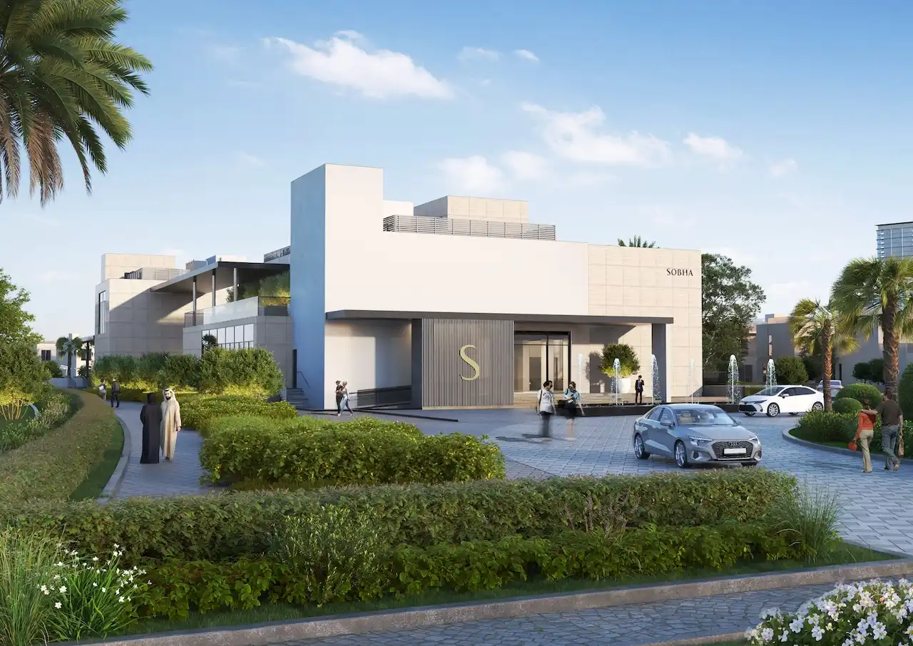 Exterior entrance view of the Sobha Elwood clubhouse featuring contemporary architecture, landscaped arrival plaza, water features, and a refined community lifestyle setting in Dubai, Presented by Tohid Fetrat