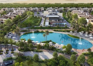 Aerial view of the Sobha Elwood clubhouse featuring a central lagoon pool, landscaped green pathways, modern low rise residences, and an integrated community lifestyle setting in Dubai, Presented by Tohid Fetrat
