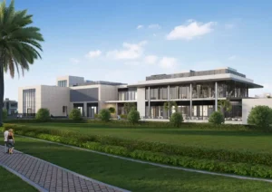 Wide exterior view of the Sobha Elwood clubhouse showcasing contemporary low rise architecture, expansive green lawns, palm lined walkways, and a serene community lifestyle setting in Dubai, Presented by Tohid Fetrat