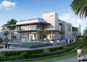 Exterior view of the Sobha Elwood clubhouse featuring modern low rise architecture, expansive glass façades, poolside terrace seating, and landscaped community surroundings in Dubai, Presented by Tohid Fetrat
