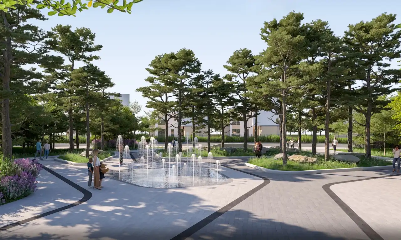 Entrance view of Taiga Park at Sobha Elwood featuring a central water fountain, landscaped walkways, mature trees, and pedestrian-friendly open spaces within a master-planned residential community in Dubai, Presented by Tohid Fetrat