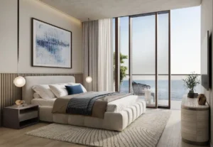 Luxury one bedroom apartment bedroom at Soulever with direct Gulf views, floor to ceiling windows, soft contemporary interiors, and refined waterfront living in Dubai. Presented by Tohid Fetrat.