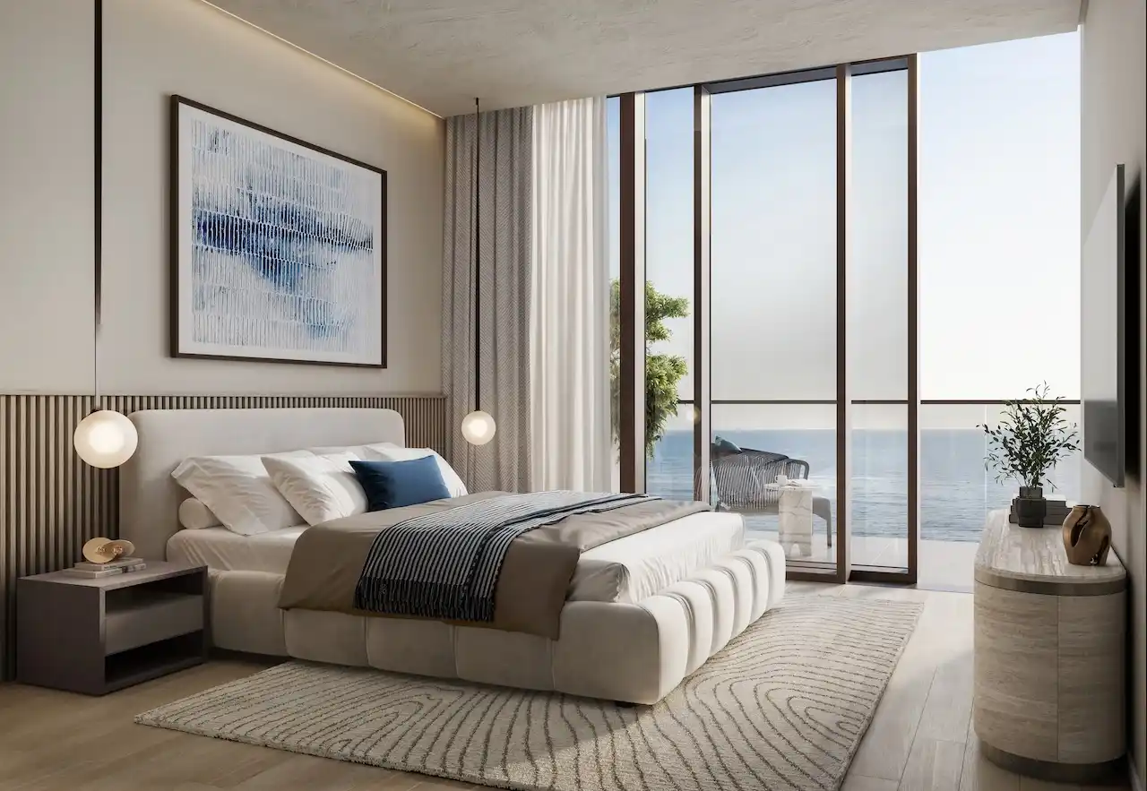 Luxury one bedroom apartment bedroom at Soulever with direct Gulf views, floor to ceiling windows, soft contemporary interiors, and refined waterfront living in Dubai. Presented by Tohid Fetrat.