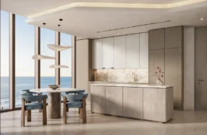Luxury open kitchen and dining area in a one bedroom apartment at Soulever with panoramic Gulf views, floor to ceiling windows, natural stone finishes, and contemporary waterfront living in Dubai. Presented by Tohid Fetrat.