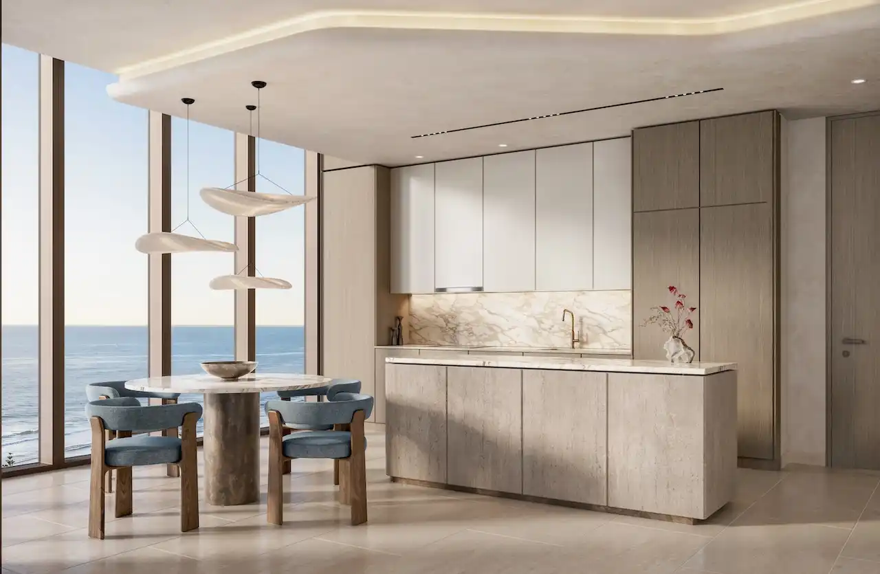 Luxury open kitchen and dining area in a one bedroom apartment at Soulever with panoramic Gulf views, floor to ceiling windows, natural stone finishes, and contemporary waterfront living in Dubai. Presented by Tohid Fetrat.